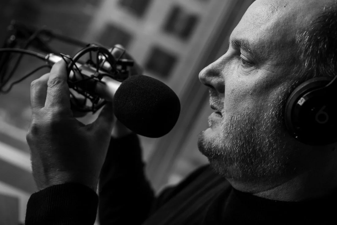 NYC personal branding photography Speaker Consultant Ken Blackwell adjusting podcast microphone