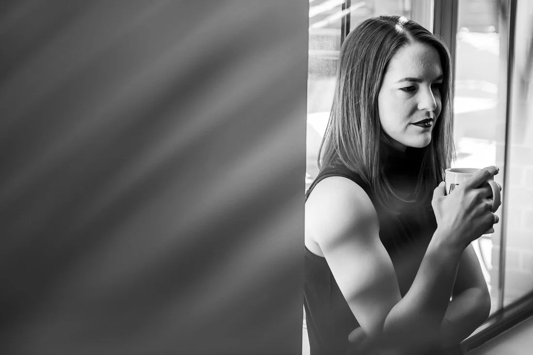 NYC personal branding photo Speaker Author Melanie Deziel thinking to herself while drinking coffee