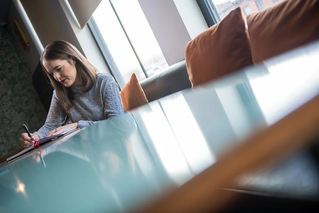 NYC personal branding photo Speaker Author Melanie Deziel brainstorming in her notepad