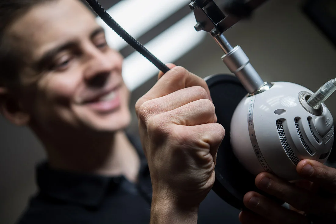 NYC Personal Brand Photography Webinar Consultant Joel Erway adjusting microphone on his desk