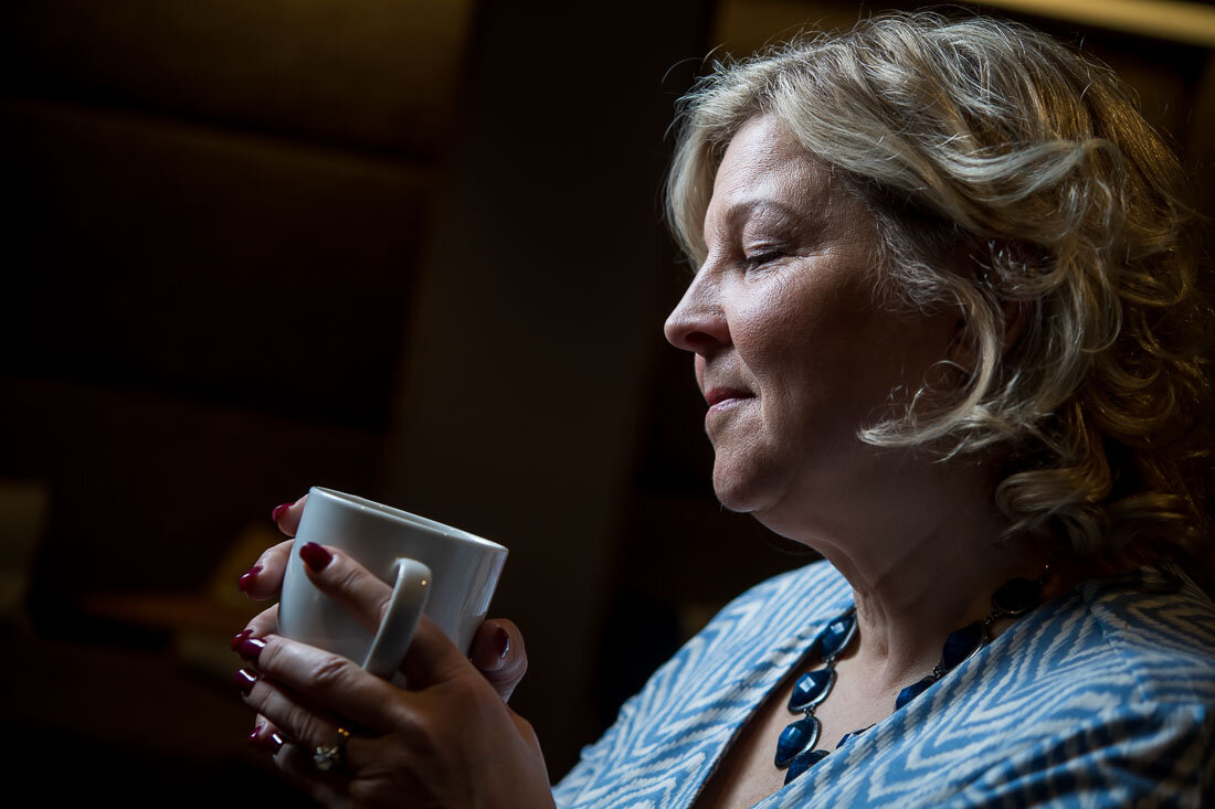 NYC Branded Lifestyle Portrait Speaker Lisa Haen ruminating while sipping on coffee