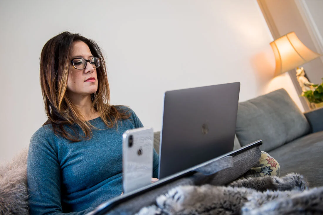 NYC branded lifestyle portraits speaker writer Terri Trespicio working on couch with laptop
