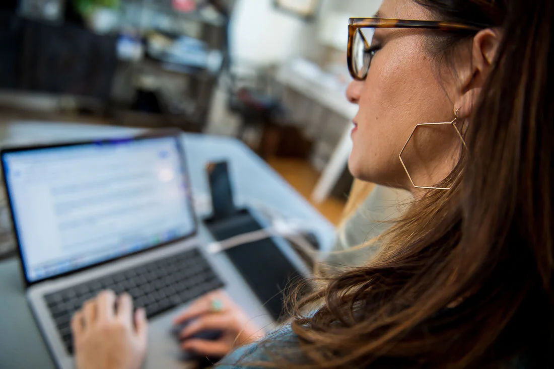 NYC branded lifestyle portraits speaker writer Terri Trespicio typing on laptop