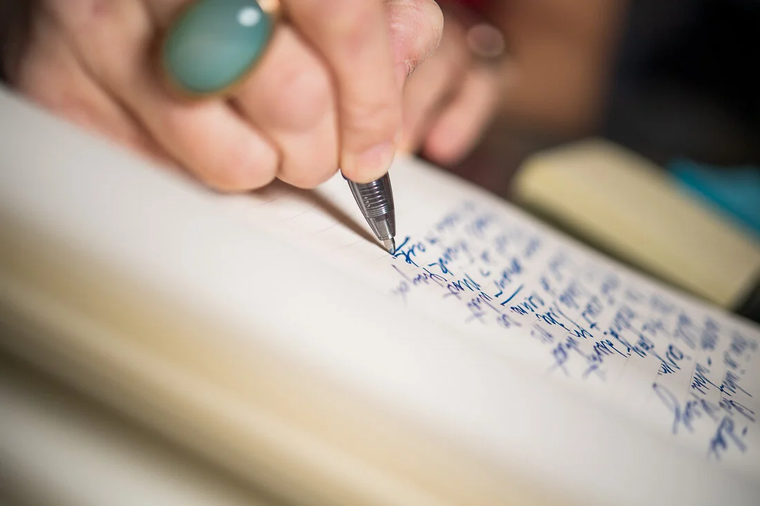 NYC branded lifestyle portraits speaker writer Terri Trespicio closeup handwriting into notebook