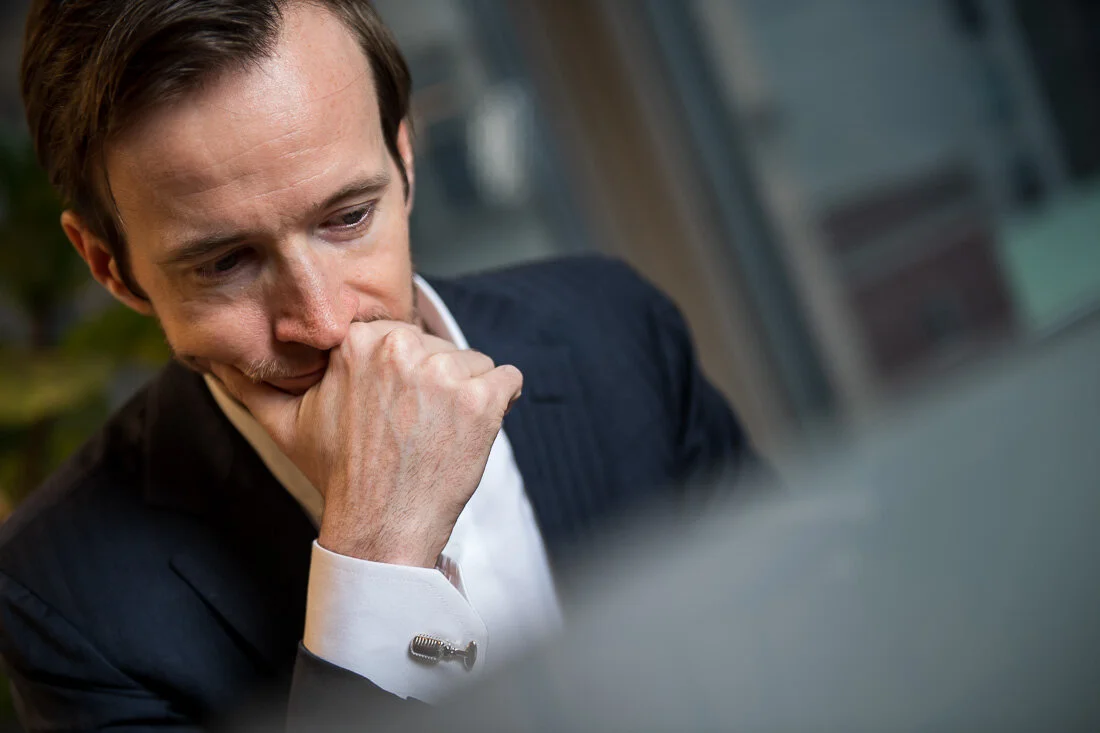 NYC Personal Branding Photography Humorist Drew Tarvin ruminating while reading on laptop