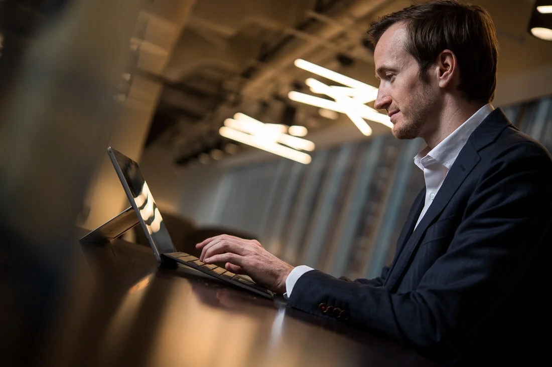 NYC Personal Branding Photography Humorist Drew Tarvin typing notes on laptop