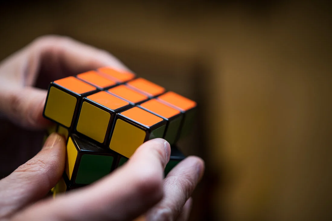 NYC Personal Branding Photography Humorist Drew Tarvin close up hands solving a rubiks cube