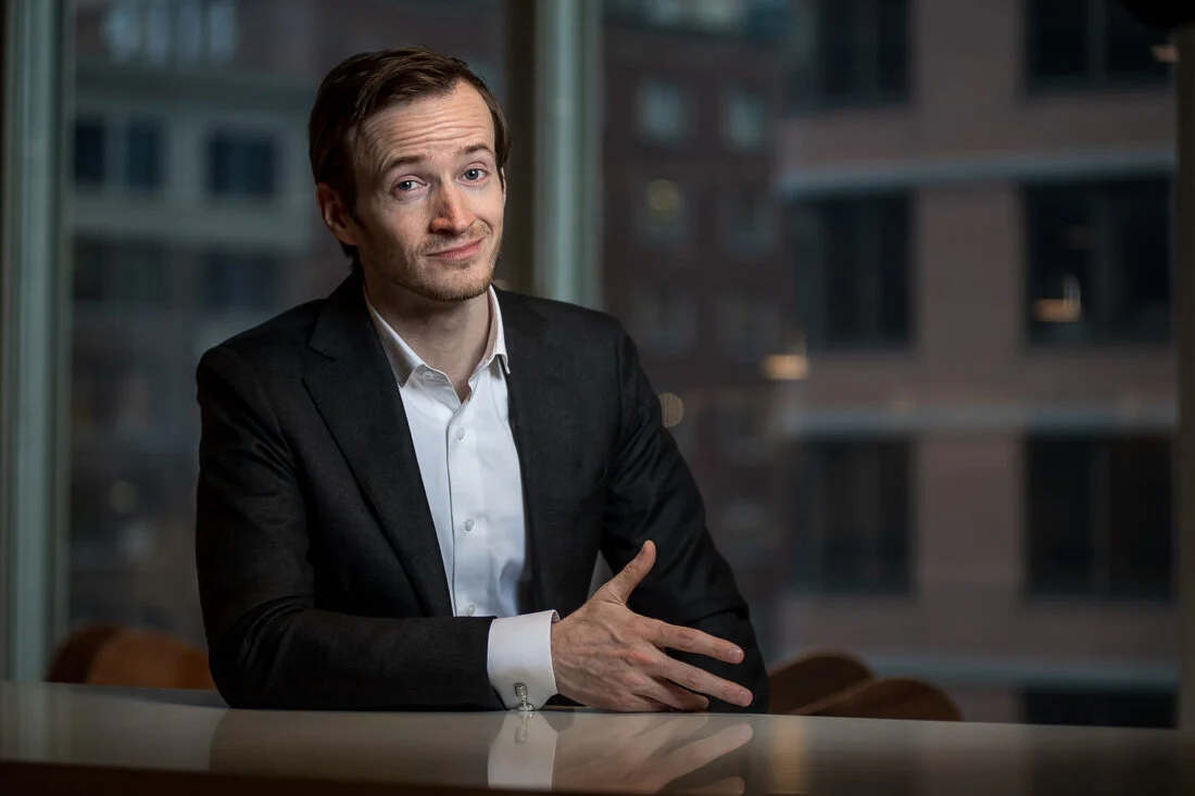 NYC Personal Branding Photography Humorist Drew Tarvin smirking in front of camera