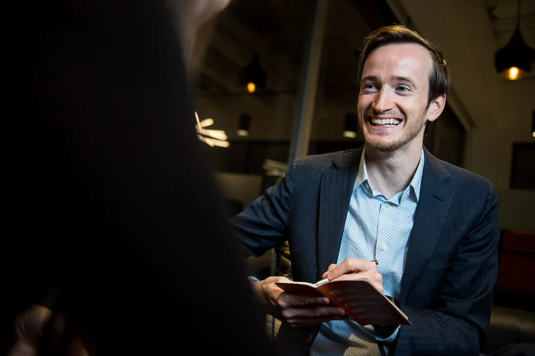 NYC Personal Branding Photography Humorist Drew Tarvin smiling during client consultation