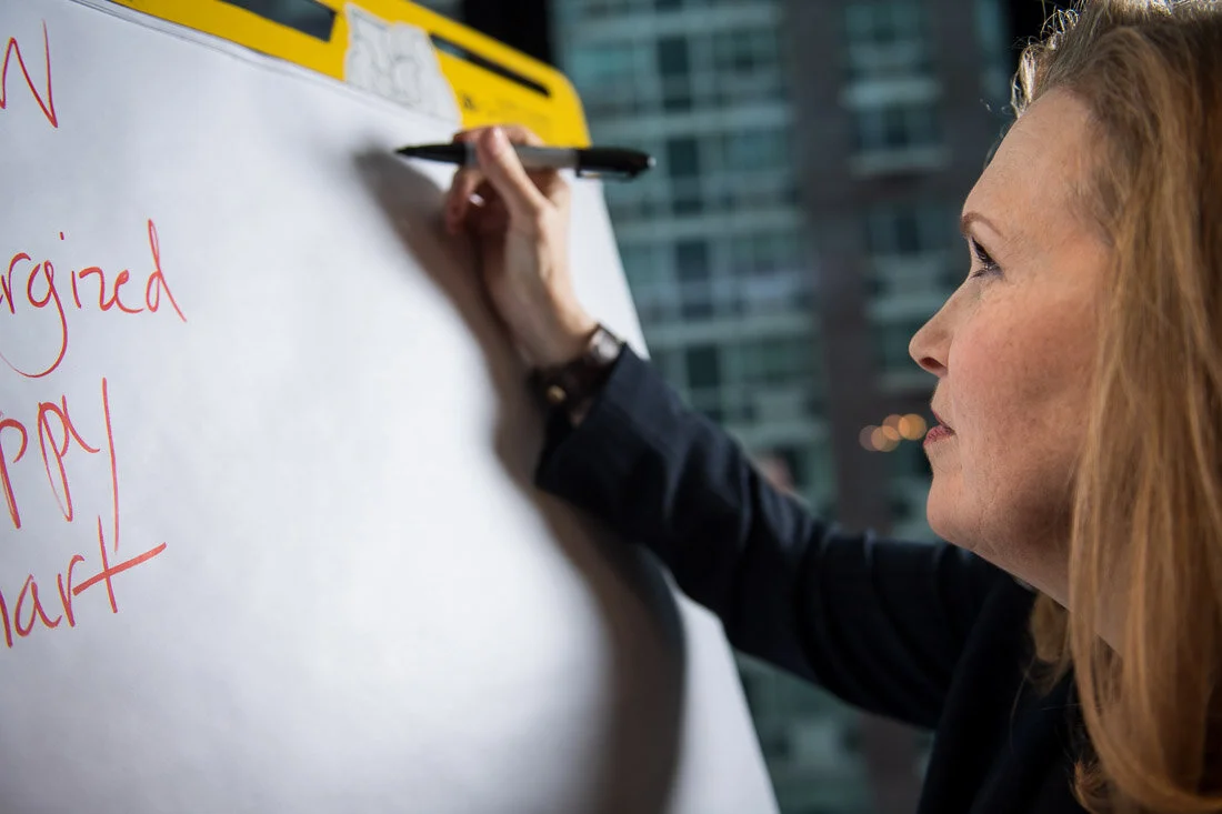 NYC personal branding photography Speaker Facilitator Jeanne Stafford writing notes on big notepad