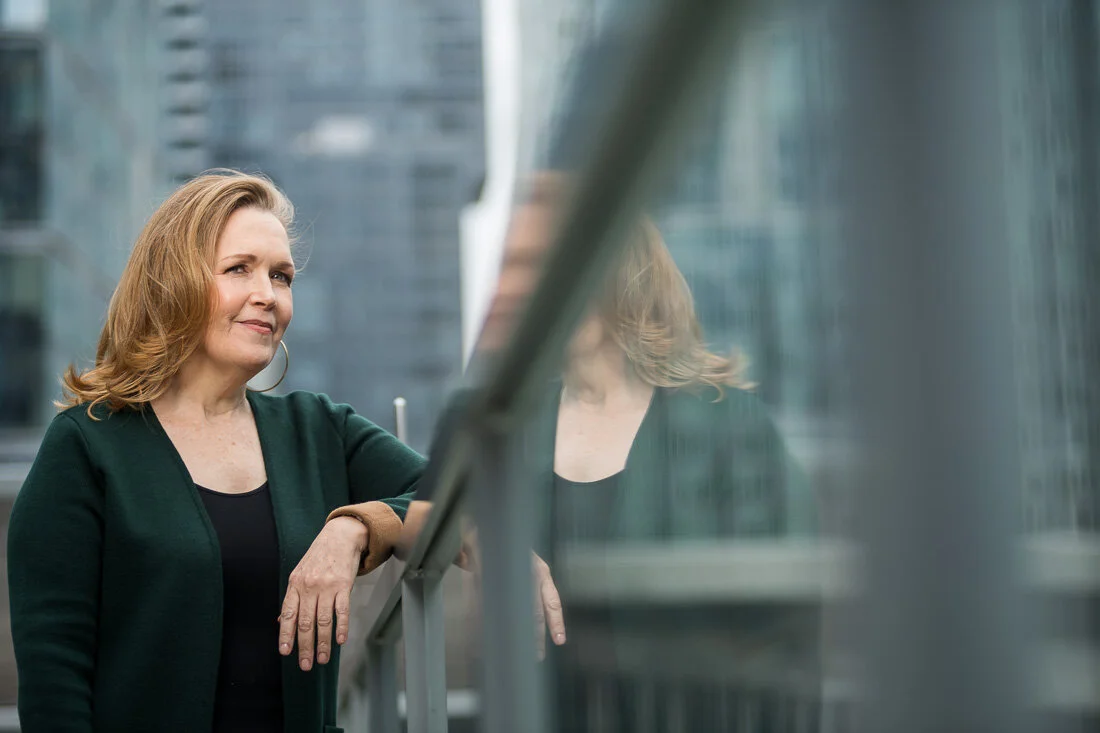 NYC personal branding photography Speaker Facilitator Jeanne Stafford looking out over ledge