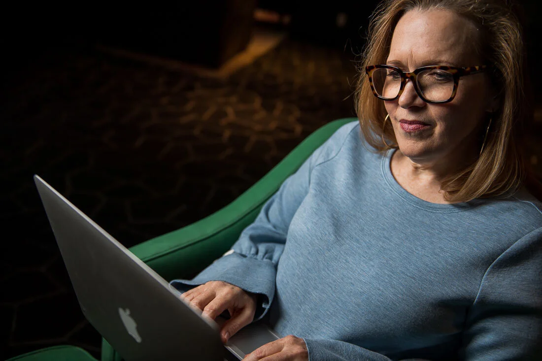 NYC personal branding photography Speaker Facilitator Jeanne Stafford working on her laptop