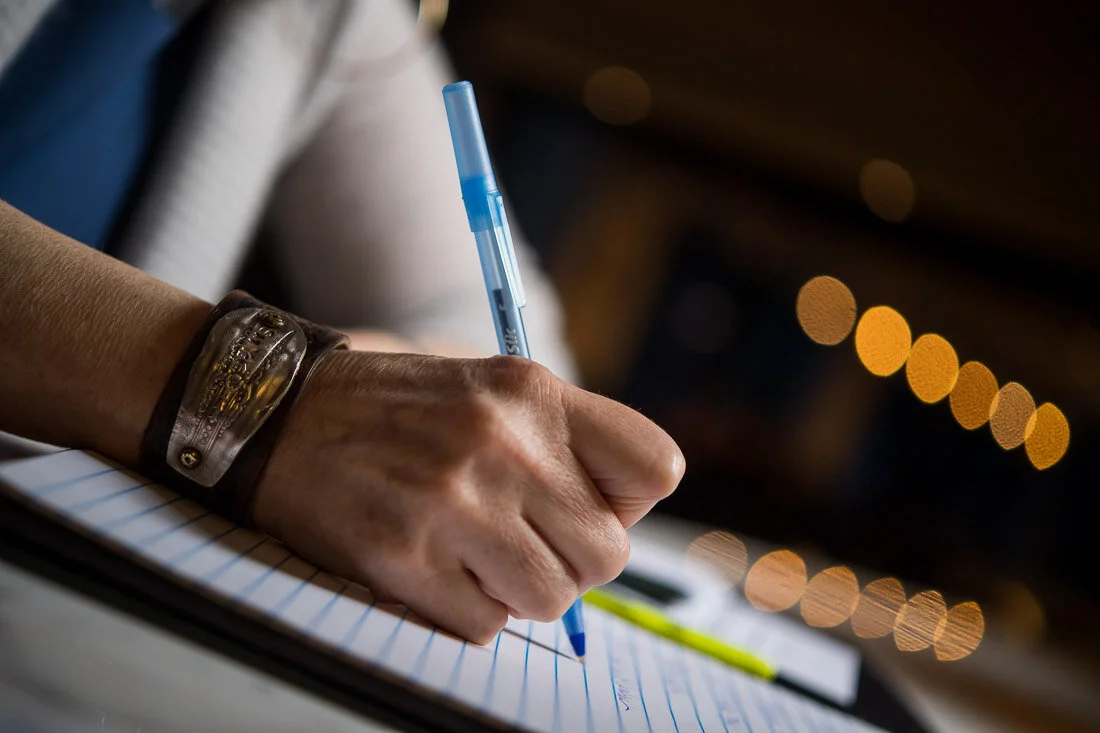 NYC personal branding photography Speaker Facilitator Jeanne Stafford close up writing talking points in notepad