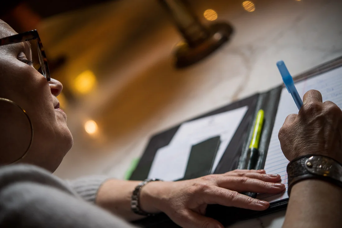NYC personal branding photography Speaker Facilitator Jeanne Stafford takin g notes in her notebook