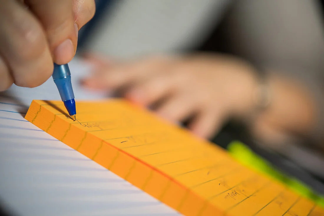 NYC personal branding photography Speaker Facilitator Jeanne Stafford close up writing notes on post it pad