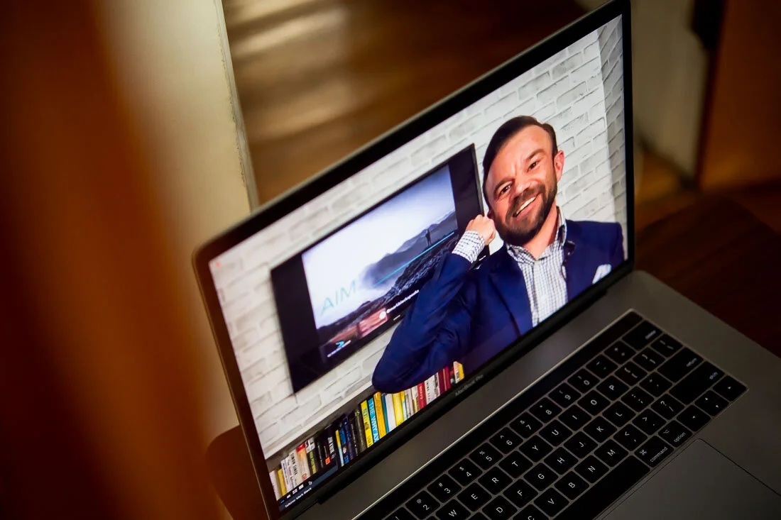 DeMato Virtual Photos Speaker Mark Black pointing to head during online presentation