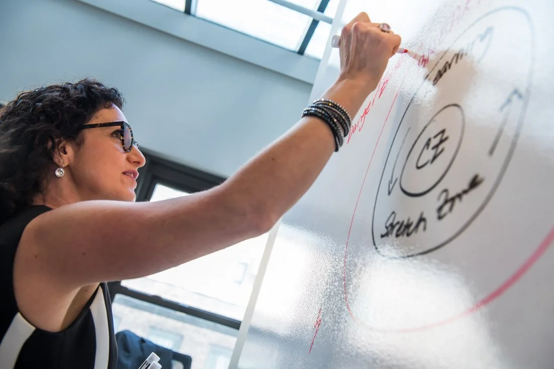 Cascade Leadership Partners brand photo Giselle writing on white board