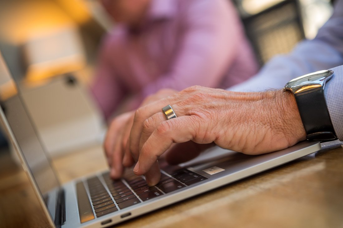 Cascade Leadership Partners brand photo closeup hands typing on laptop