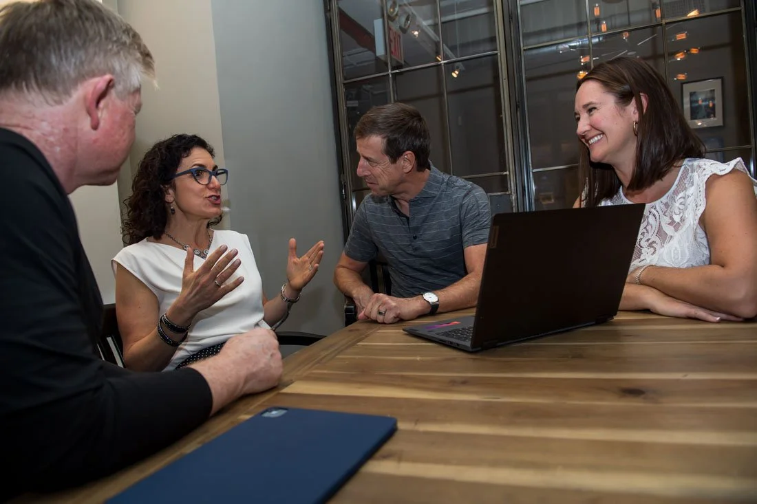 Cascade Leadership Partners brand photo Giselle speaking during team meeting