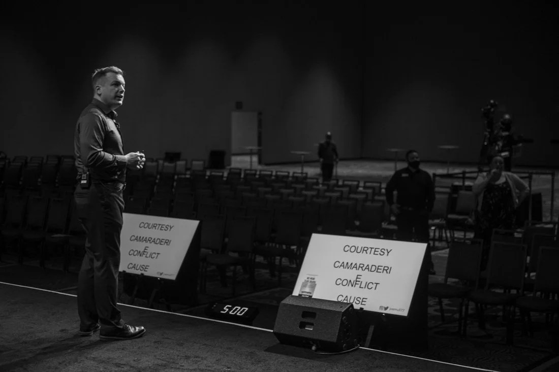 brand photo joe mull on stage preparing for keynote