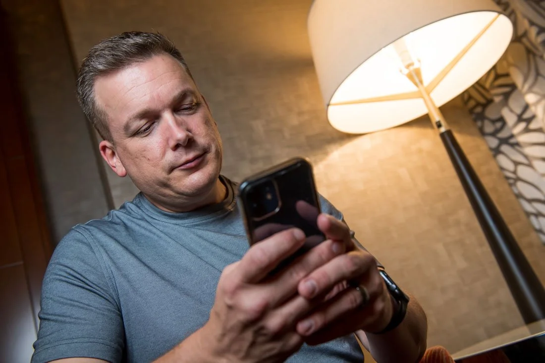 brand photo joe mull looking at his phone