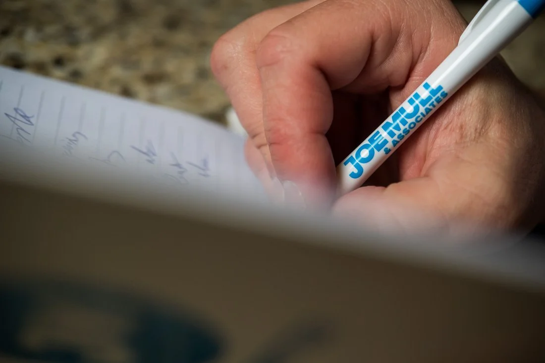 brand photo joe mull close up of his pen writing in notebook
