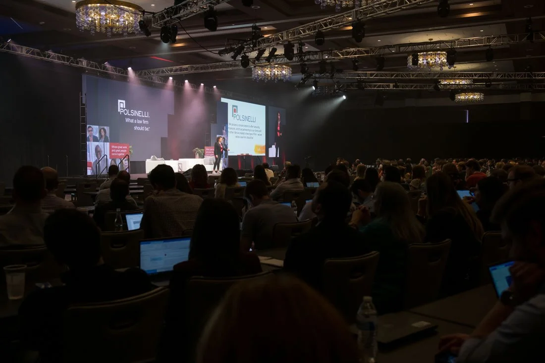 live event photo Speaker Author Heather R Younger wide shot on stage speaking