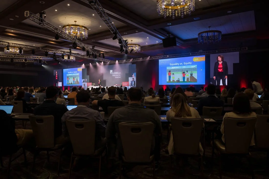 live event photo Speaker Author Heather R Younger wide shot addressing participants
