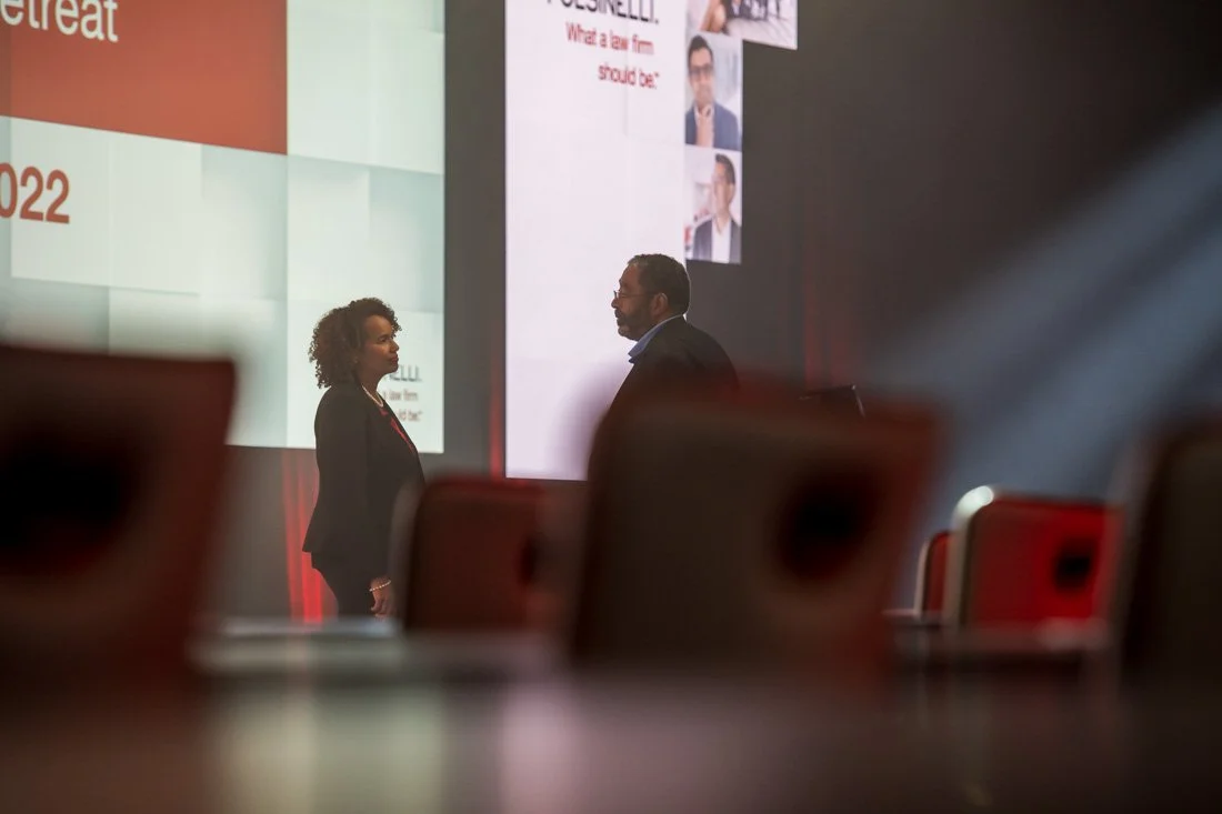 live event photo Speaker Author Heather R Younger speaking with colleague before keynote
