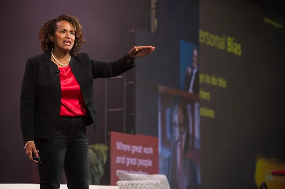 live event photo Speaker Author Heather R Younger demonstratively sharing her point on stage