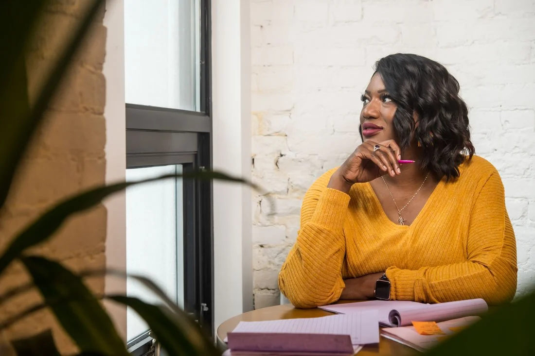 personal branding photo speaker author Jasmine Brett Stringer brainstorming ideas while looking out window