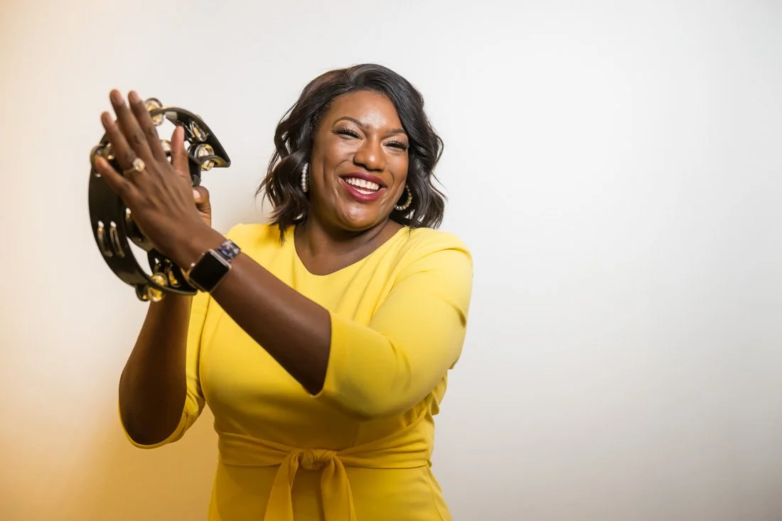 personal branding photo speaker author Jasmine Brett Stringer playing tambourine