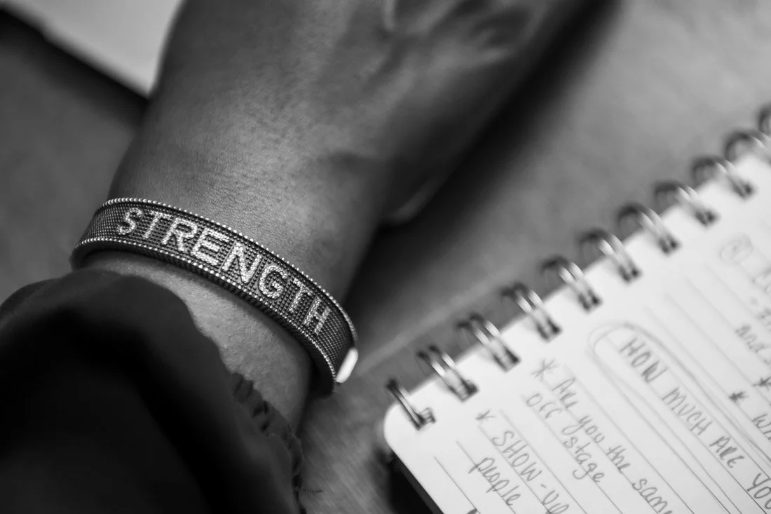 personal branding photo speaker author Jasmine Brett Stringer wearing STRENGTH bracelet