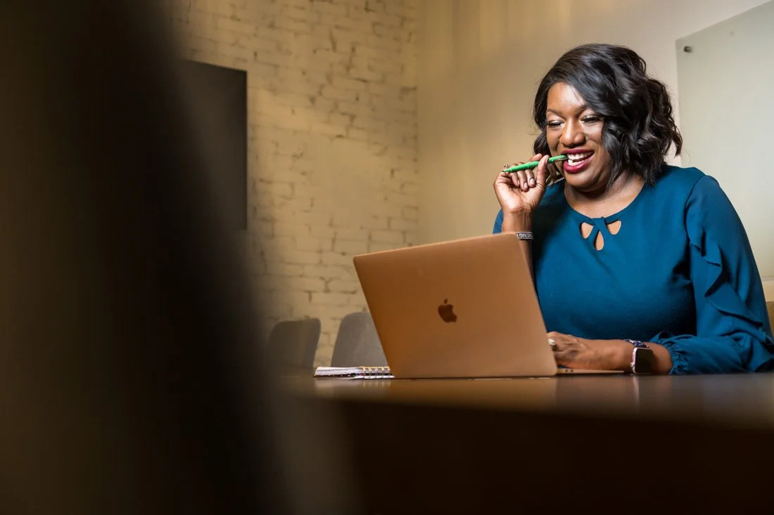 personal branding photo speaker author Jasmine Brett Stringer working on computer