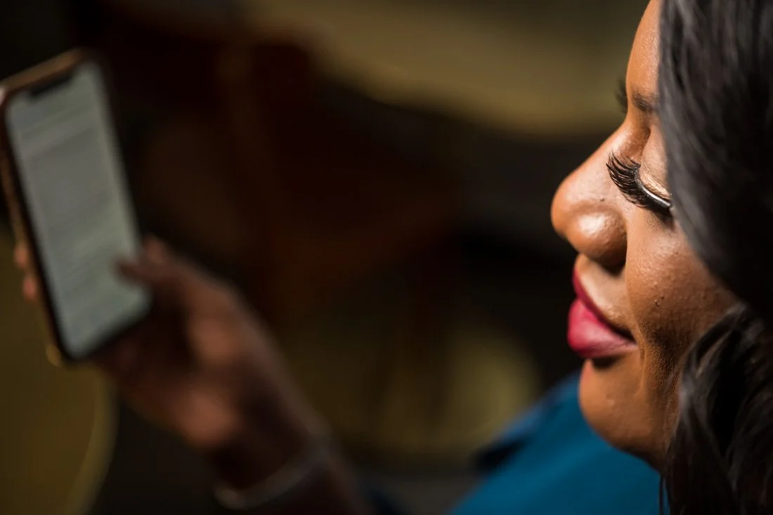 personal branding photo speaker author Jasmine Brett Stringer working on her phone