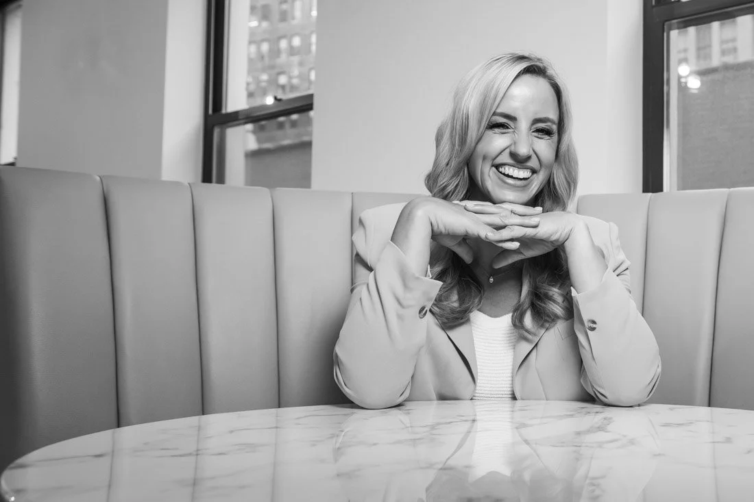 personal brand photo speaker expert Rachel DeAlto candid smile portrait sitting at table