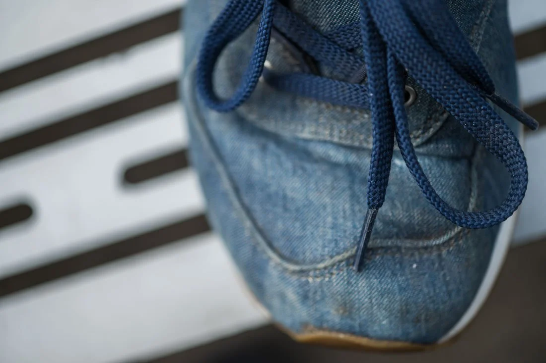 new balance 574 sneakerhead collection high angle toe and laces on metal bench