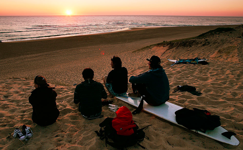 surfing beach sunset.png
