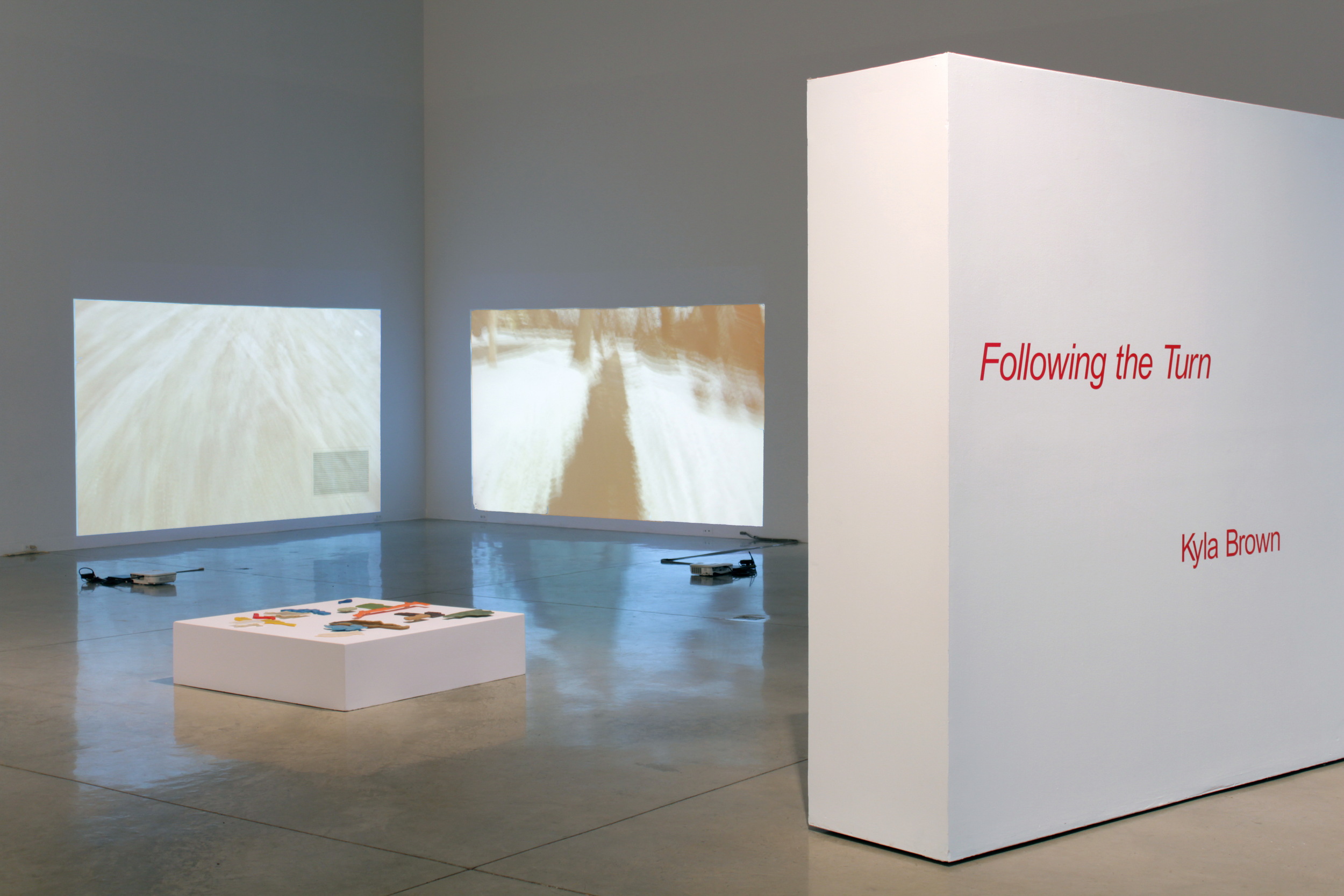 installation view, title with "Lines of Desire" & " Walking: train yard" & "Walking: block" videos