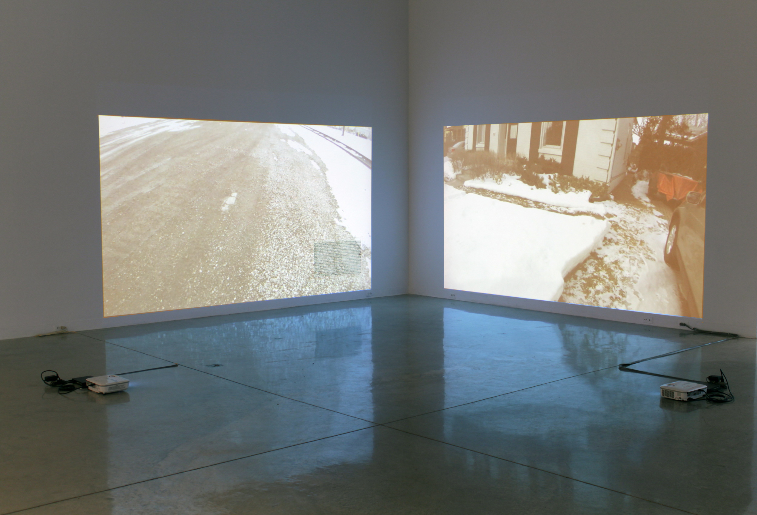 installation view, "Walking: train yard" & "Walking: block" videos