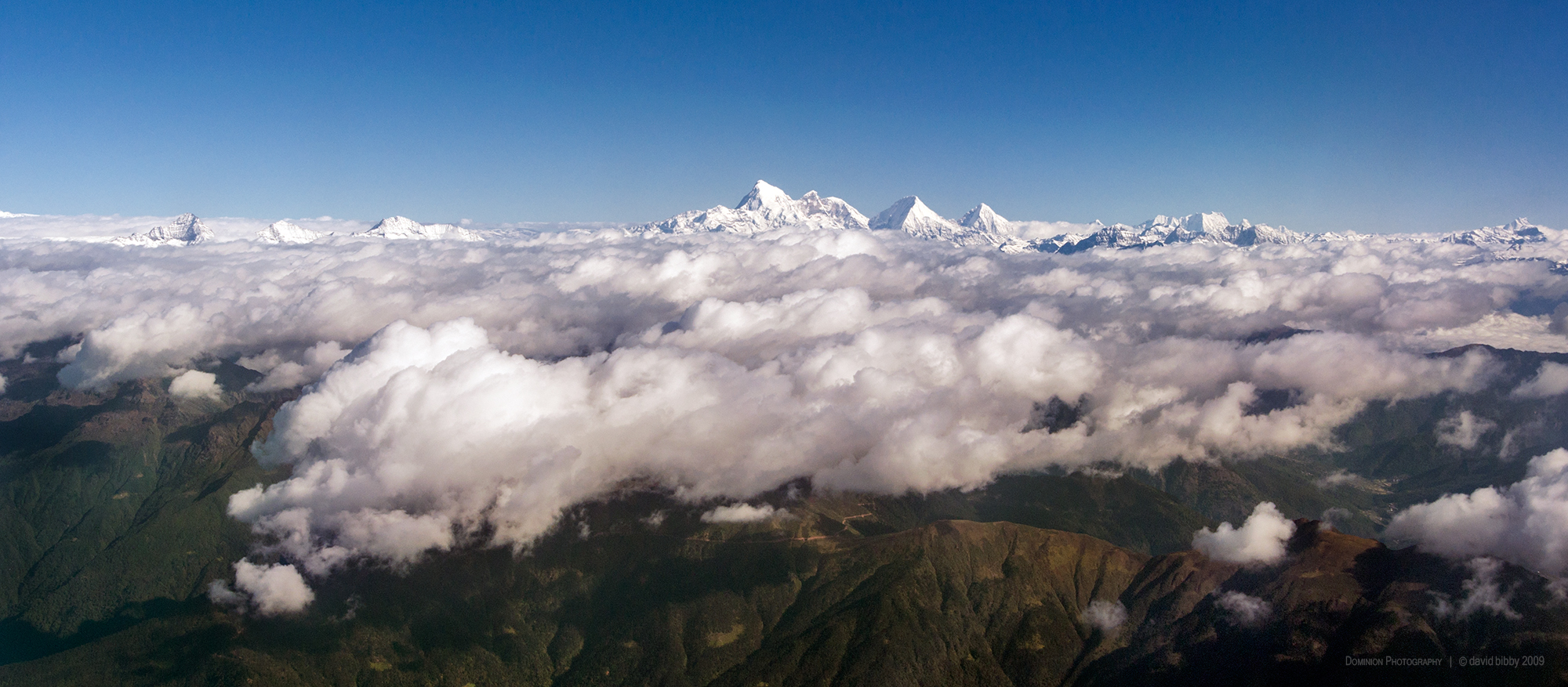   4 nations under cloud  - The peak at left is Kanchenjunga (8586m). The high peaks in the centre of the shot are Jomolhari (7314m), Jomolhari II (6935m), Jitchu Drake (6850m) and Tsheri Kang (6526m). Nepal and India, Bhutan and Tibet. 
