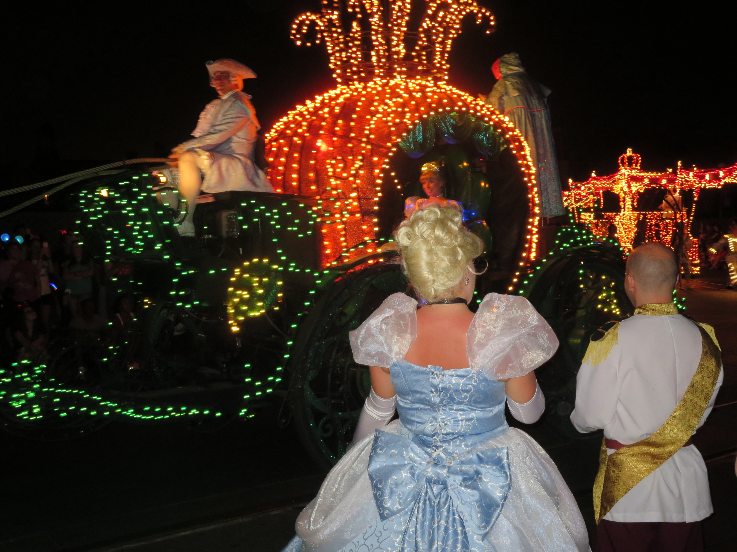 Cinderella in the Electrical Light Parade with guests showing their Disney Side