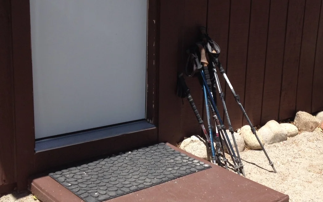 Hiker poles at rest outside a cabin at the Base Camp