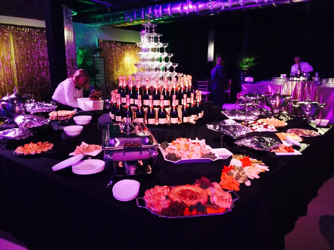 Putting the food station in the center of the room creates a gorgeous focal point. It also encourages guest flow throughout the space, making it perfect for a cocktail format party.