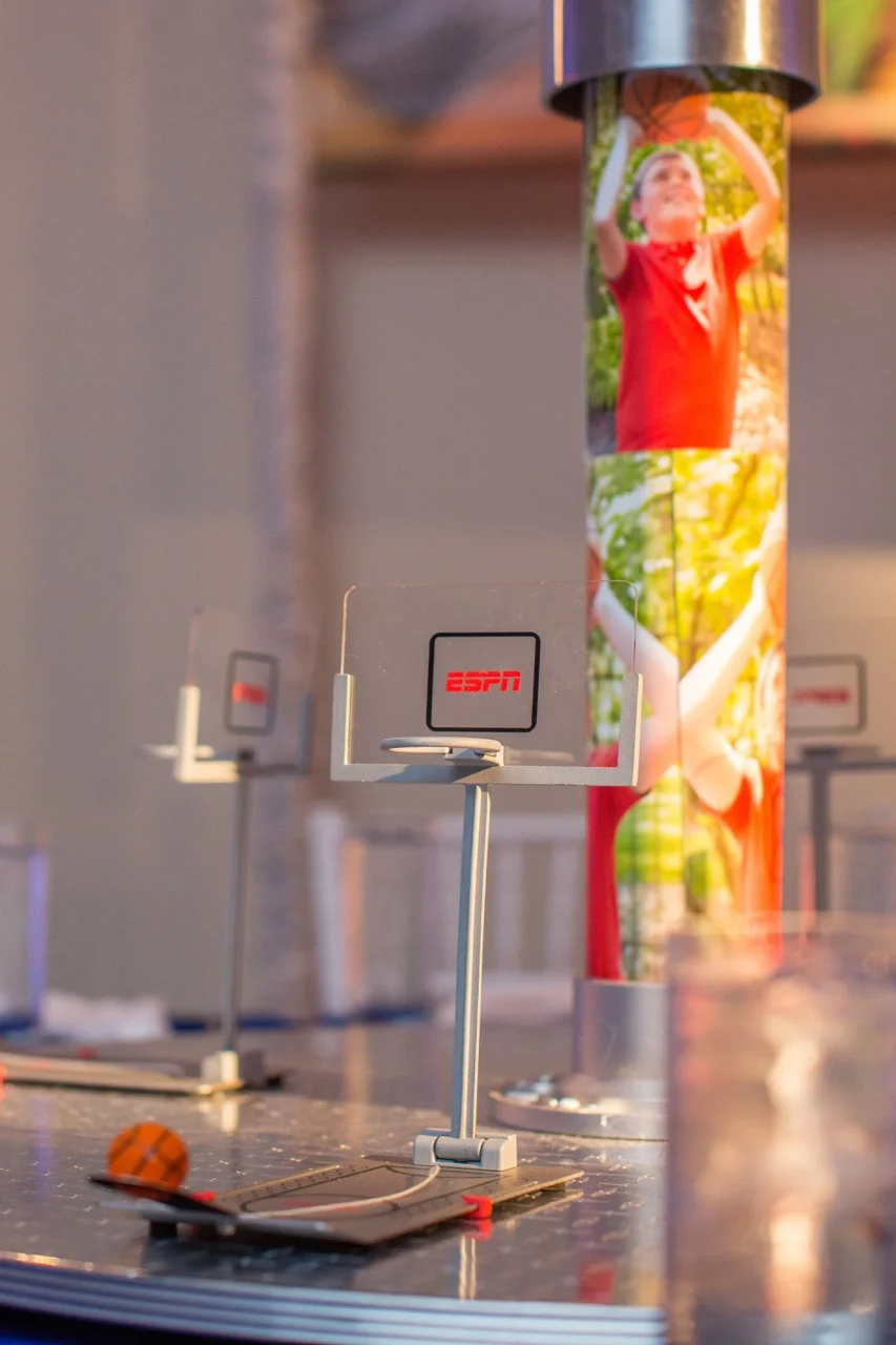 Interactive mini games on a rotating base for a basketball theme centerpiece