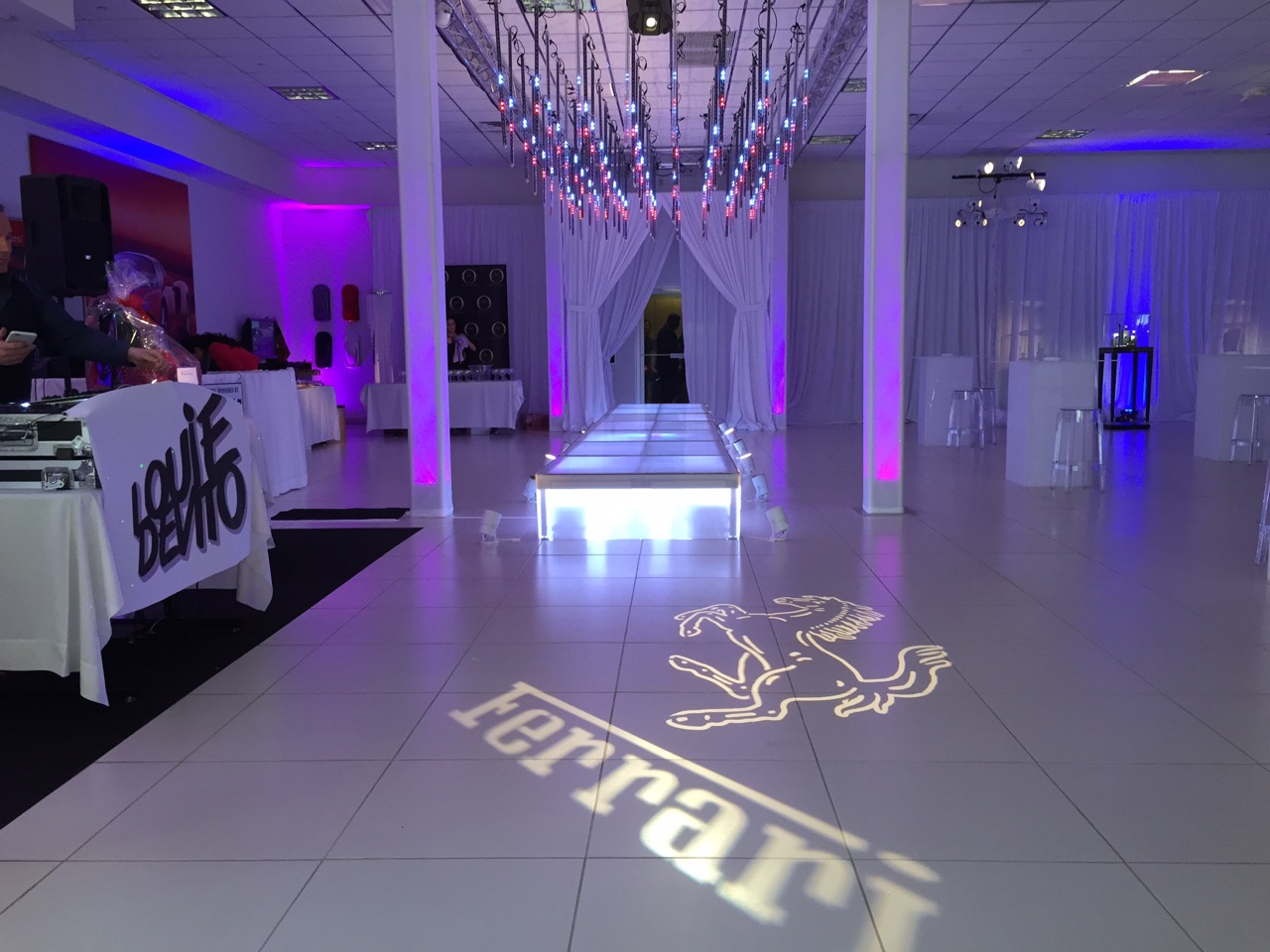 LED light tubes, truss, and custom logo projection provided by Eggsotic Events • Photo by Josh Casto