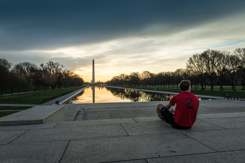 Dan Dzombak stretching before a run at sunrise on the National Mall, shot for Destination DC's DC Cool campaign.