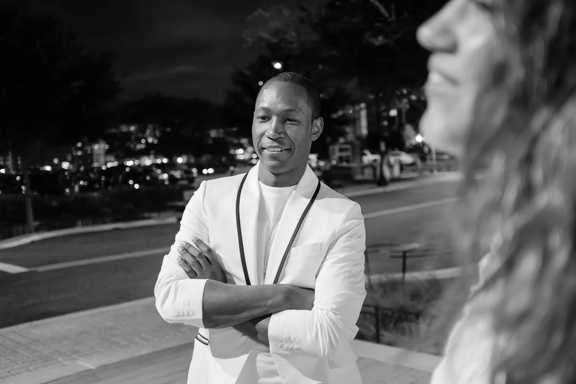 The Washington Post's Clinton Yates waits for his Uber, one of the event partners of Diner En Blanc.