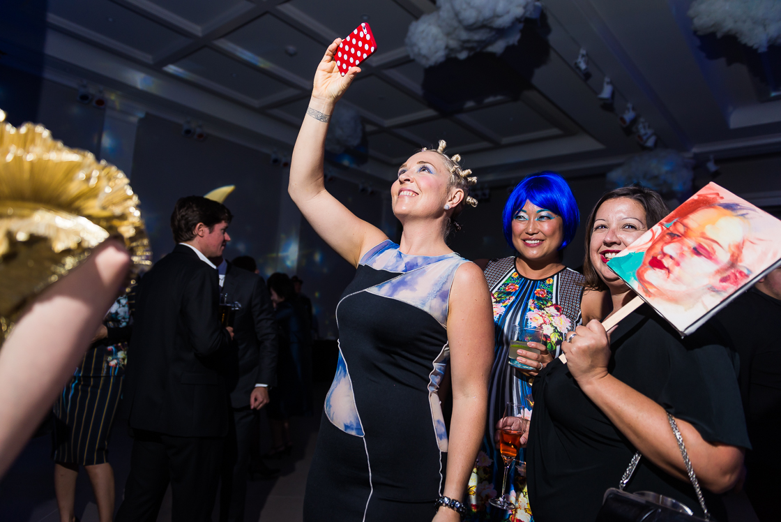 It's not a themed party without someone dressed as Miley Cyrus - Kate Damon did the honors at the surrealist Night Nouveau benefit, as Grace Koh and Victoria Reis of Transformer Gallery looked on. Reis' look was all black, with a portrait of herself as a mask.