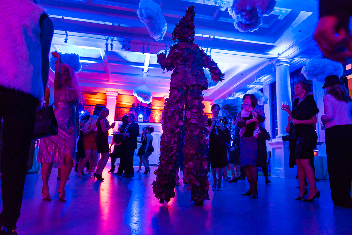 Guests at the surrealism-themed Night Nouveau party danced the night away amid dramatic performance artists, like this leafy dancer on stilts.